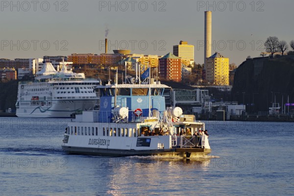 A ferry in daylight with an urban skyline in the background, Stockholm, Djurgarden, Sweden, Stockholm, Sweden