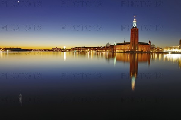 A nocturnal skyline with illuminated building and reflecting lights in the water, Stadshuset, Nobel Prize, Stockholm, Sweden