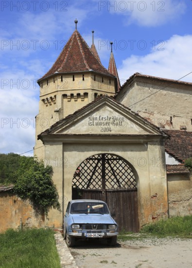 The fortified church of Seica Mica, German Kleinschelken, in front of it a Daccia 1300, a community in Sibiu district in Transylvania, Romania
