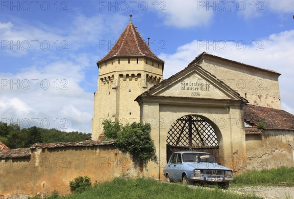 The fortified church of Seica Mica, German Kleinschelken, in front of it a Daccia 1300, a community in Sibiu district in Transylvania, Romania