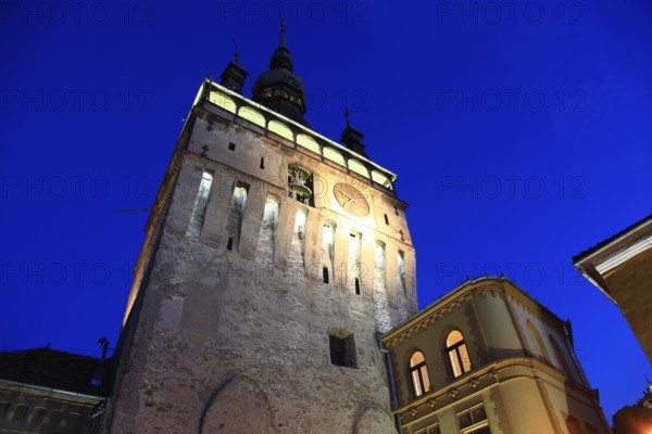 Romania, hour tower at the blue hour in the historic old town of Sighisoara, German Sighisoara, town in Mures district in Transylvania, UNESCO World Heritage Site