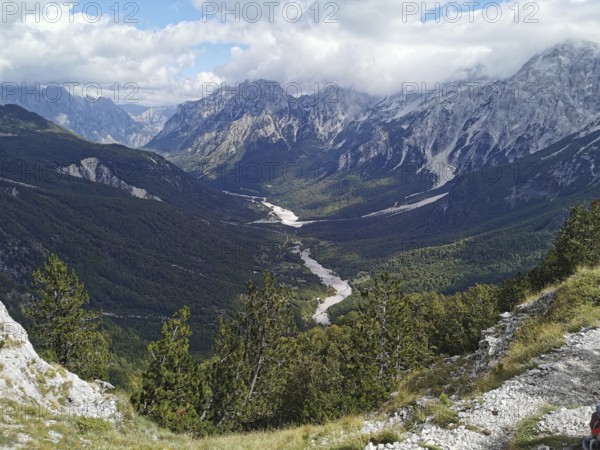 Panorama, far-reaching view of a valley with a river surrounded by majestic mountains, Peaks of the Balkans, hiking in the Albanian Alps National Park, Albania