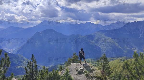 Hikers on peaks with views of mountain scenery and dramatic skies, Peaks of the Balkans, hiking in the Albanian Alps National Park, Albania