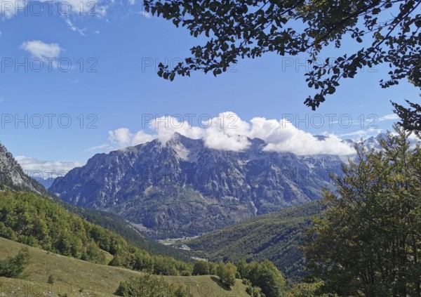 Extensive mountain landscape with idyllic valley and dramatic cloud formation, Peaks of the Balkans, hiking in the Albanian Alps National Park, Albania