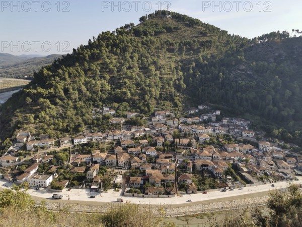 Panoramic view of a city on a hill surrounded by river and lush nature, Berat, Albania