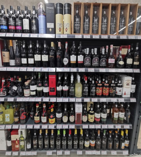 Shelf full of various port wines, wine bottles and spirits in a shop, Lagos, Algarve, Portugal