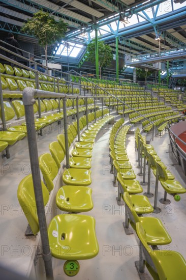Green seats in a modern sports hall, arranged in rows along a grandstand, Sindelfingen Glass Palace, Böblingen district, Germany