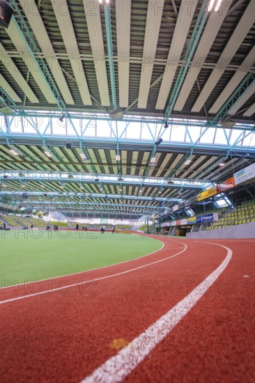 Interior view of a modern sports hall with red running track and green area under steel girders, Sindelfingen Glass Palace, Böblingen district, Germany