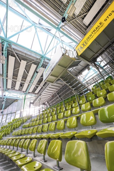 Yellow seats in a stand in a modern sports hall, Glaspalast Sindelfingen, Böblingen district, Germany