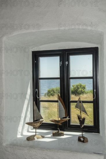 Window with sailboat decorations facing the sea in Smygehamn, Sweden's southernmost point in Trelleborg municipality, Baltic Sea, Skåne County, Sweden, Scandinavia