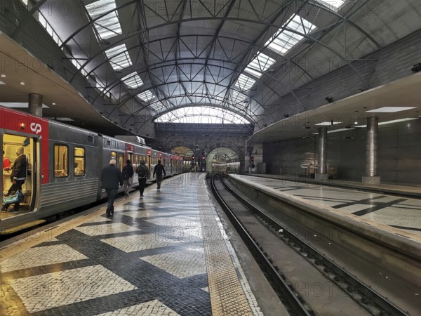 A modern train station with open roofs where trains arrive and people travel, Lisbon railway station, Portugal