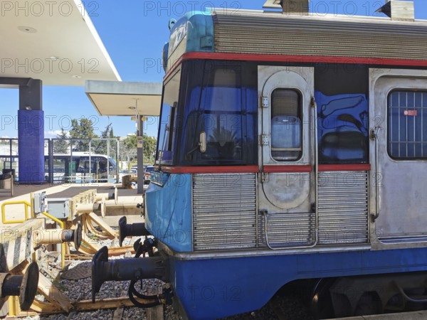 A blue train stands in the station area in bright sunshine, Lagos, Algarve, Portugal