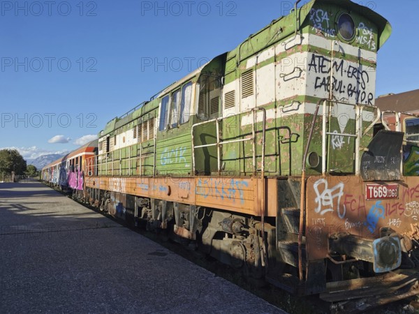Old locomotive with graffiti on an abandoned train station, Albania