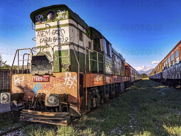 Colorful locomotive with graffiti in the sun on abandoned tracks, Albania