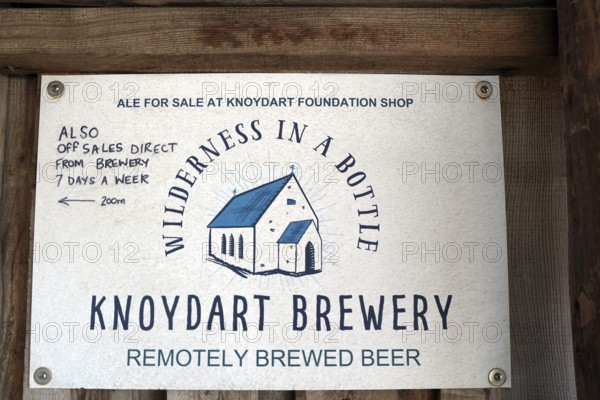 Brewery sign with stylized house and text about ale sales in the Knoydart region, Highlands, Scotland, Great Britain