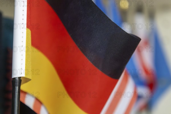 Close-up of a German flag in front of other flags (USA, Europe etc.)