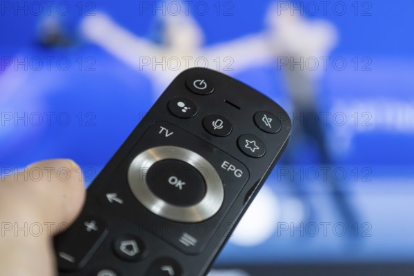 Close-up of a remote control during a broadcast of the Olympic Games in Milan/Cortina