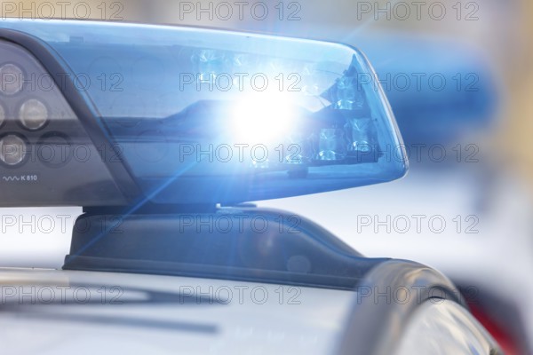 Symbolic image police operation: close-up of a blue light on a police car (digitally reworked)