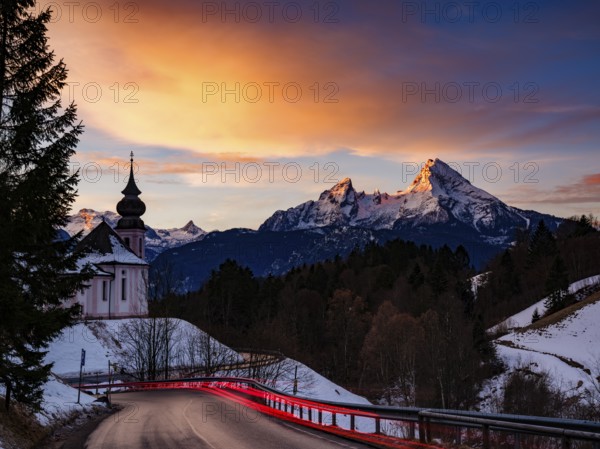 Watzmann and the pilgrimage church of Maria Gern at dawn, traces of light on the road in the foreground, long exposure, Berchtesgaden, Berchtesgadener Land, Upper Bavaria, Germany