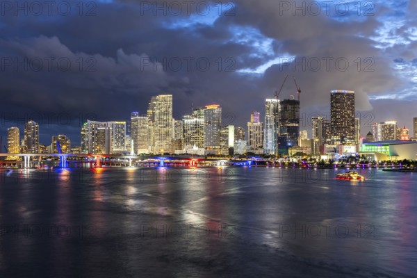 Miami skyline with high-rise real estate in downtown by the ocean at night in Miami, USA