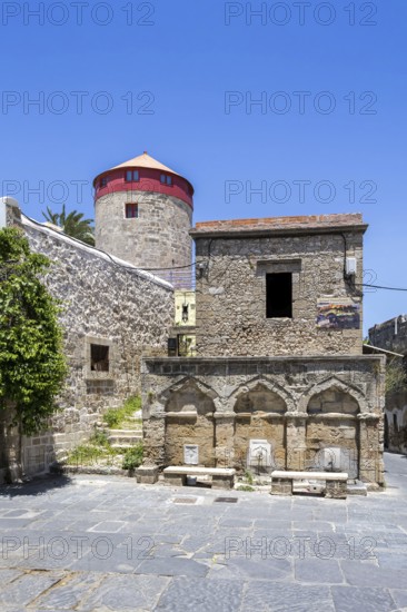 Ottoman fountain and windmill in the historic old town from the Middle Ages on the island of Rhodes, Greece