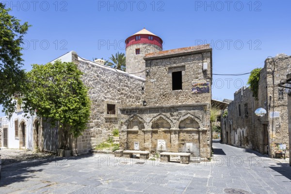 Ottoman fountain and windmill in the historic old town from the Middle Ages on the island of Rhodes, Greece
