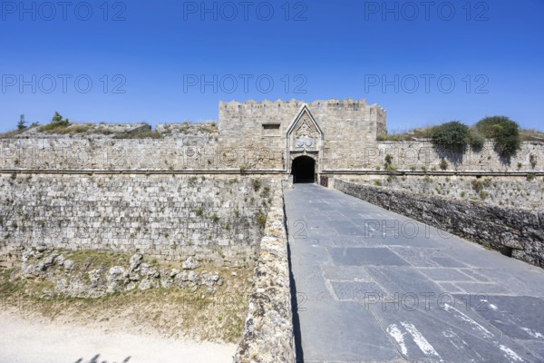 Red gate from the Middle Ages in the city wall of the historic old town on the island of Rhodes, Greece