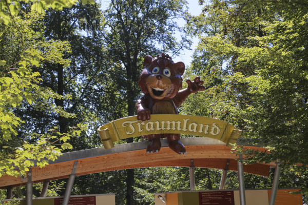 Amusement park Traumland auf der Bärenhöhle, amusement park in Sonnenbühl, entrance, sign, figure, replica bear, leaves, Sonnenbühl, Swabian Jura, Baden-Württemberg, Germany