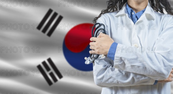 Healthcare professional with South Korea flag background. Professional doctor holding stethoscope on South Korea flag background