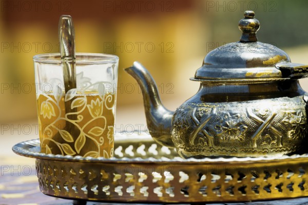 Silver teapot and tea glass with peppermint tea, Morocco