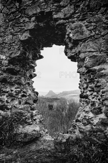 Detailed view, view through historic walls of the Mägdeberg castle ruins to the neighboring Hohenkrähen Hegau volcano, black and white photography, Mühlhausen-Ehingen, Hegau, Konstanz district, Baden-Württemberg, Germany