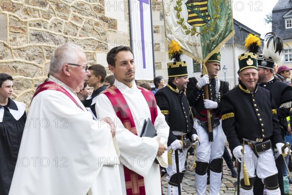 Bergstreit Day 2025 in Schneeberg, miners of all trades proudly wear their habit on this traditional day, Grand Mountain Parade arrived at St. Wolfgang Church in Schneeberg, Ore Mountains, Saxony, Germany