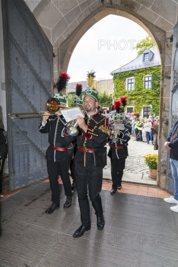 Historic mining day of miners 2025 in Schneeberg, miners of all trades proudly wear their habit on this traditional day, Great mountain parade moving into the church of St. Wolfgang in Schneeberg, Ore Mountains, Saxony, Germany