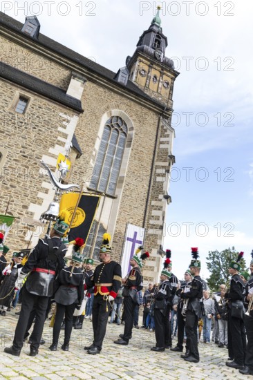 Bergstreit Day 2025 in Schneeberg, miners of all trades proudly wear their habit on this traditional day, Grand Mountain Parade arrived at St. Wolfgang Church in Schneeberg, Ore Mountains, Saxony, Germany