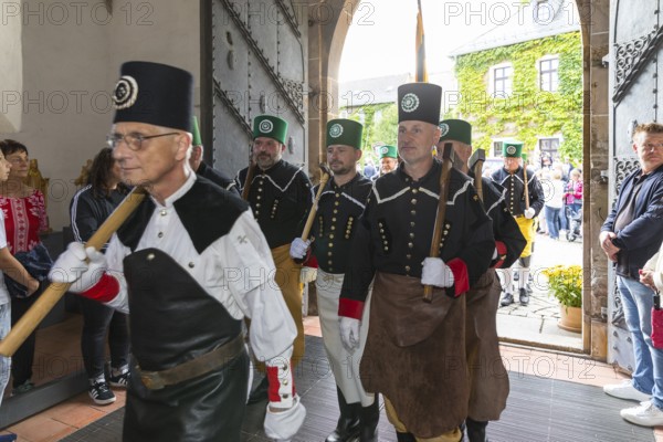 Historic mining day of miners 2025 in Schneeberg, miners of all trades proudly wear their habit on this traditional day, Great mountain parade moving into the church of St. Wolfgang in Schneeberg, Ore Mountains, Saxony, Germany