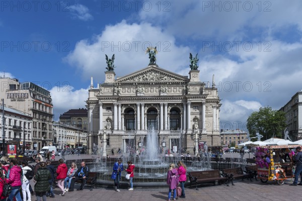 Hustle and bustle at the Opera Fountain, the Opera House in the back, Lviv, Ukraine