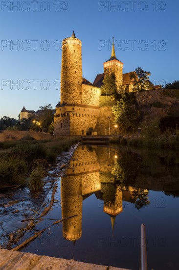 Old water art and St. Michael's Church are reflected in the Spree, night view, Bautzen, Saxony, Germany