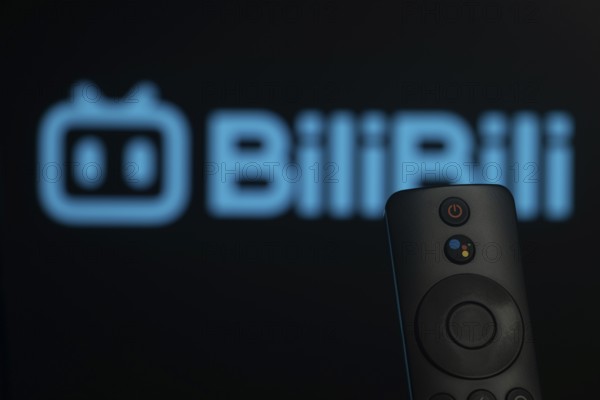 Dhaka, Bangladesh- 21 Jan 2026: Close-up of a smart TV remote control against a blurred Bilibili logo
