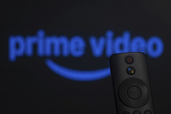 Dhaka, Bangladesh- 21 Jan 2026: Close-up of a smart TV remote control against a blurred Amazon Prime Video logo
