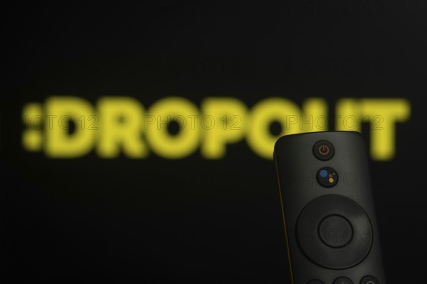 Dhaka, Bangladesh- 21 Jan 2026: Close-up of a smart TV remote control against a blurred Dropout logo