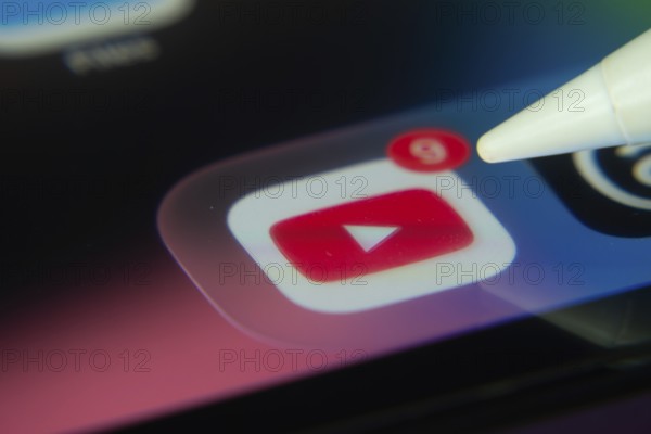 16 Nov 2025- Dhaka, Bangladesh: Stylus touching the youtube app icon with a notification on a smartphone screen