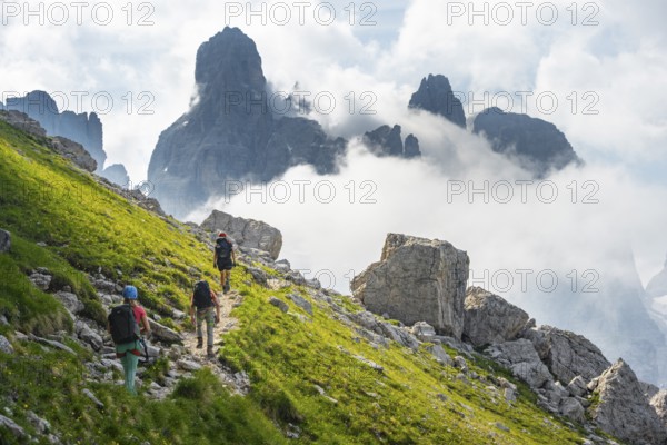 Climbers on a hiking trail, rocky mountain landscape with fog, Via Ferrata SOSAT via ferrata, Brenta Mountains, Trentino, Italy