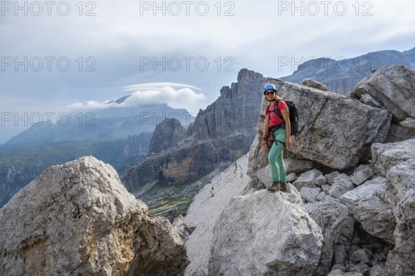 Female mountaineer on a hiking trail, rocky mountain landscape, Via Ferrata SOSAT via ferrata, Brenta Mountains, Trentino, Italy