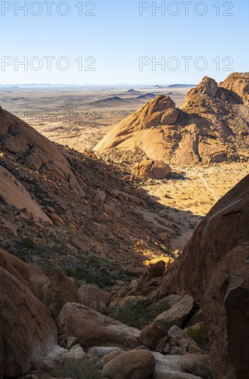 Rocks and low-lying desert plain in contrasting lighting, Spitzkoppe, Namibia