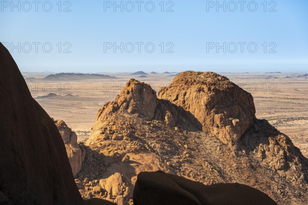 Majestic rock formations in the dry desert landscape under blue sky, Spitzkoppe, Namibia