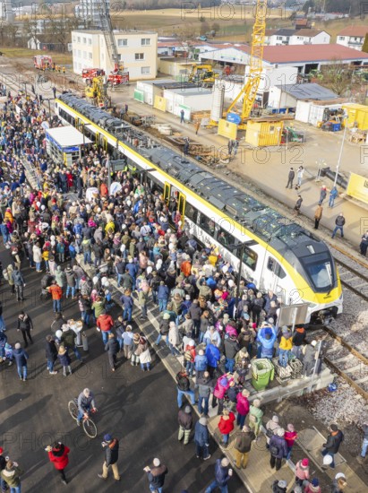 Many people gather at an event near a construction site by train at a train station, opening of the Hermann Hesse Railway, Calw, Germany