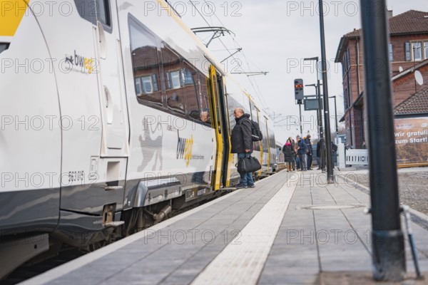 People get on a train at a municipal platform, opening of the Hermann Hesse Railway, Calw, Germany