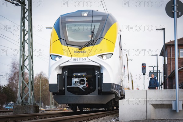 Modern locomotive on tracks in front of a train station under cloudy sky, opening of the Hermann Hesse Railway, Calw, Germany