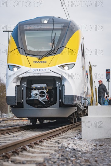 Close-up of a modern locomotive on rails under grey skies, opening of the Hermann Hesse Railway, Calw, Germany