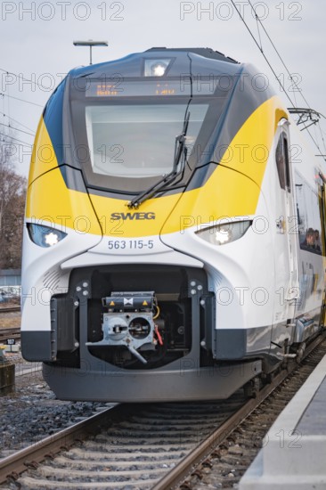 Close-up of the modern front of a white train with yellow elements, opening of the Hermann Hesse Railway, Calw, Germany